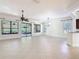 Spacious living room features tile flooring, a ceiling fan, and access to a screened lanai at 133 Indian Wells Ave, Kissimmee, FL 34759