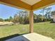 Back porch view with view of the spacious yard featuring trees beyond the fence at 15069 Sw 29Th Avenue Rd, Ocala, FL 34473