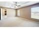 Bright primary bedroom boasting large windows, a ceiling fan and hall access at 15069 Sw 29Th Avenue Rd, Ocala, FL 34473
