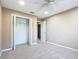 This bedroom features neutral walls and carpet, closet, and ceiling fan at 15069 Sw 29Th Avenue Rd, Ocala, FL 34473