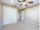 Comfortable bedroom features a ceiling fan, closet and plenty of natural light at 15069 Sw 29Th Avenue Rd, Ocala, FL 34473