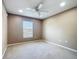 This bedroom features neutral walls and carpet, window, and ceiling fan at 15069 Sw 29Th Avenue Rd, Ocala, FL 34473