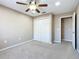 Bright, carpeted bedroom with ceiling fan and a closet providing ample storage space at 15069 Sw 29Th Avenue Rd, Ocala, FL 34473