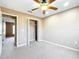 This bedroom features neutral walls and carpet, closet, and ceiling fan at 15069 Sw 29Th Avenue Rd, Ocala, FL 34473