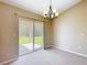 Cozy dining area features sliding glass doors to the backyard and a modern chandelier at 15069 Sw 29Th Avenue Rd, Ocala, FL 34473