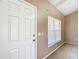 Bright entryway featuring a white door and a window with blinds at 15069 Sw 29Th Avenue Rd, Ocala, FL 34473