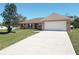 Lovely one-story home with a spacious two-car garage, well-kept lawn, and beautiful shade tree at 15069 Sw 29Th Avenue Rd, Ocala, FL 34473