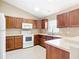 Well-equipped kitchen featuring wood cabinets, white appliances, and a breakfast bar at 15069 Sw 29Th Avenue Rd, Ocala, FL 34473
