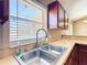 A double basin stainless steel sink overlooks a bright window in this kitchen at 15069 Sw 29Th Avenue Rd, Ocala, FL 34473