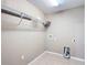 This is a laundry room with a white tile floor and hookups for a washer and dryer at 15069 Sw 29Th Avenue Rd, Ocala, FL 34473