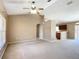 Open-concept living room featuring vaulted ceilings, carpet flooring, and natural light at 15069 Sw 29Th Avenue Rd, Ocala, FL 34473