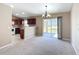 Open floor plan living room features sliding glass doors and easy access to the modern kitchen at 15069 Sw 29Th Avenue Rd, Ocala, FL 34473
