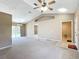 Spacious living room featuring vaulted ceilings, carpet flooring, and sliding glass doors leading to the backyard at 15069 Sw 29Th Avenue Rd, Ocala, FL 34473