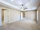 Spacious main bedroom with neutral color, ceiling fan, and doorway access to ensuite bathroom at 15069 Sw 29Th Avenue Rd, Ocala, FL 34473