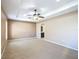 Spacious main bedroom with a tray ceiling, ceiling fan, and an ensuite bathroom entrance, offering comfort and privacy at 15069 Sw 29Th Avenue Rd, Ocala, FL 34473