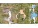 Aerial view shows a home with lush trees, circular driveway, and neighborhood layout at 1590 Twelve Oaks Cir, Kissimmee, FL 34744
