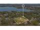 Aerial shot showcasing the property surrounded by trees and near a lake at 1590 Twelve Oaks Cir, Kissimmee, FL 34744