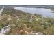 Aerial view showcases the home's proximity to a serene lake and lush green surroundings at 1590 Twelve Oaks Cir, Kissimmee, FL 34744