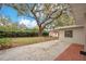 Backyard featuring a patio area, mature trees, and a storage shed at 1590 Twelve Oaks Cir, Kissimmee, FL 34744