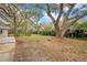 Expansive backyard featuring mature trees and partial fencing offers a private outdoor space at 1590 Twelve Oaks Cir, Kissimmee, FL 34744