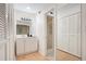 Bathroom with white cabinets, a sink and a mirror, and a view to the shower at 1590 Twelve Oaks Cir, Kissimmee, FL 34744