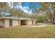 Charming home exterior with stone accents and a well-maintained front yard at 1590 Twelve Oaks Cir, Kissimmee, FL 34744
