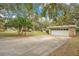 Attached garage with stone accents and driveway, offering ample parking and curb appeal at 1590 Twelve Oaks Cir, Kissimmee, FL 34744