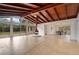 Spacious living room with unique hanging fireplace and walls of windows at 1590 Twelve Oaks Cir, Kissimmee, FL 34744