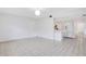 Bright room with tile floors showing a hall door and an open entrance to the kitchen at 1590 Twelve Oaks Cir, Kissimmee, FL 34744