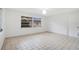 Bright room with tile floors, a single pendant light, one window, and a door to the hall at 1590 Twelve Oaks Cir, Kissimmee, FL 34744