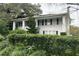 Charming two-story home with a white exterior, dark shutters, and lovely landscaping at 1625 E Ridgewood St, Orlando, FL 32803