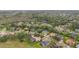 An aerial shot of a residential area showcasing homes, tree coverage, and well-maintained green spaces at 1686 Shadowmoss Cir, Lake Mary, FL 32746