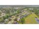 A high aerial perspective of a suburban neighborhood nestled among trees and winding roads at 1686 Shadowmoss Cir, Lake Mary, FL 32746