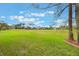 Expansive grassy backyard with mature trees providing a serene outdoor space at 1686 Shadowmoss Cir, Lake Mary, FL 32746