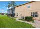 Lush backyard featuring a screened-in lanai, manicured lawn, and neatly trimmed shrubbery at 1686 Shadowmoss Cir, Lake Mary, FL 32746