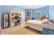 Sky blue bedroom with a computer desk, natural lighting, and tan carpet at 1686 Shadowmoss Cir, Lake Mary, FL 32746