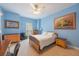 Blue bedroom with desk, natural light, and wooden dresser at 1686 Shadowmoss Cir, Lake Mary, FL 32746