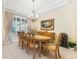 Formal dining room with a large window, elegant chandelier, and classic decor at 1686 Shadowmoss Cir, Lake Mary, FL 32746