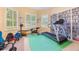 Spacious workout room with a treadmill and weightlifting equipment, including shelving for DVDs at 1686 Shadowmoss Cir, Lake Mary, FL 32746
