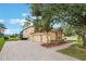 Lovely exterior showcasing a three-car garage, a brick driveway, and well-maintained landscaping at 1686 Shadowmoss Cir, Lake Mary, FL 32746