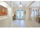 Bright foyer with tile flooring, elegant lighting, and an open view to the dining area at 1686 Shadowmoss Cir, Lake Mary, FL 32746