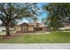 Attractive home featuring a stone-accented facade, lush green lawn, and curved pathway to the front entrance at 1686 Shadowmoss Cir, Lake Mary, FL 32746