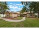 Spacious home with well-manicured lawn, stone accents, and a curved brick walkway leading to the front entrance at 1686 Shadowmoss Cir, Lake Mary, FL 32746