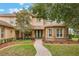 Charming home with a beautiful stone facade, mature landscaping and a welcoming brick pathway to the front door at 1686 Shadowmoss Cir, Lake Mary, FL 32746