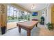 Well lit game room includes a pool table, recessed lights, ceiling fan, and large glass sliding doors at 1686 Shadowmoss Cir, Lake Mary, FL 32746