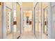 Hallway featuring mirrored closet doors, tan carpet, and recessed lighting at 1686 Shadowmoss Cir, Lake Mary, FL 32746
