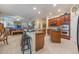 Spacious kitchen and breakfast bar featuring granite countertops, wood cabinets, and open floorplan at 1686 Shadowmoss Cir, Lake Mary, FL 32746