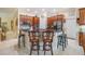 Open-concept kitchen boasts dark granite counters, wood cabinets, and barstool seating at 1686 Shadowmoss Cir, Lake Mary, FL 32746