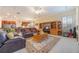 Inviting living room open to the kitchen, featuring a built-in bookcase and comfortable seating at 1686 Shadowmoss Cir, Lake Mary, FL 32746