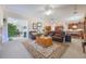 Spacious living room with an area rug, comfortable seating, and views of the adjacent dining room at 1686 Shadowmoss Cir, Lake Mary, FL 32746